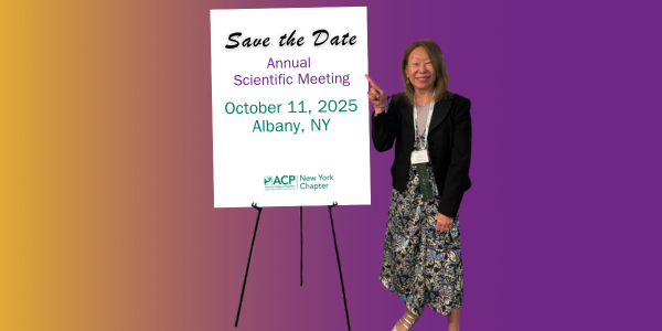 Dr Lee pointing to a sign that says Save teh Date Annual Scientific Meeting October 11, 2025 in Albany, NY